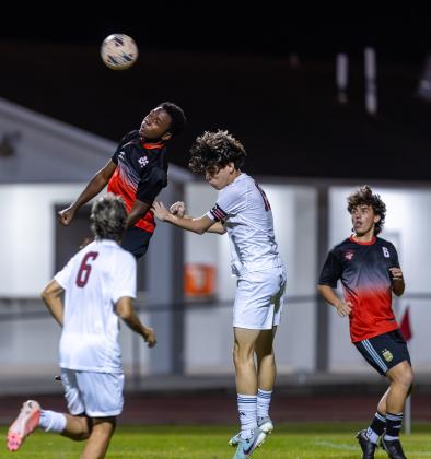 Gateway's Keandre Octave goes up for a header amongst the Innovation midfield in Tuesday's District 5A-7 championship. PHOTO/TAYLOR MCFEE