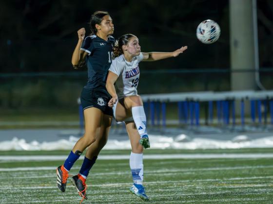 Harmony's Jada Bloodworth and Celebration's Oriana Moreno fight for a 50-50 ball in Harmony's 1-0 district championship win. PHOTO/MARIO CASAMALHUAPA