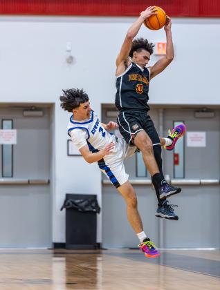 St. Cloud's Diomar Ortiz fights Osceola's Jordan Mason for a rebound. PHOTO/TAYLOR MCFEE