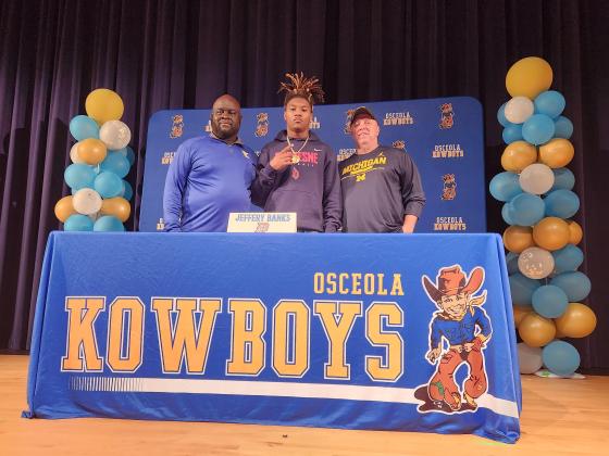 With friends, family and coaches looking on, Osceola’s Jeffery Banks signed Wednesday to play defensive back at Duquesne University in Pittsburgh. PHOTO/KEN JACKSON