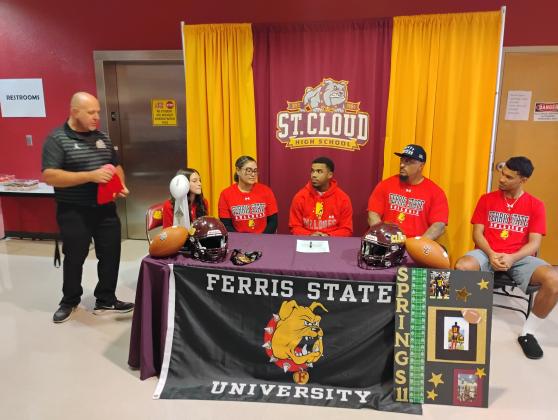 Surrounded by his family, Alex Springs inks his letter of intent to play football for defending NCAA Division II National Champion Ferris State, where he is projected to play cornerback. PHOTO/J. DANIEL PEARSON
