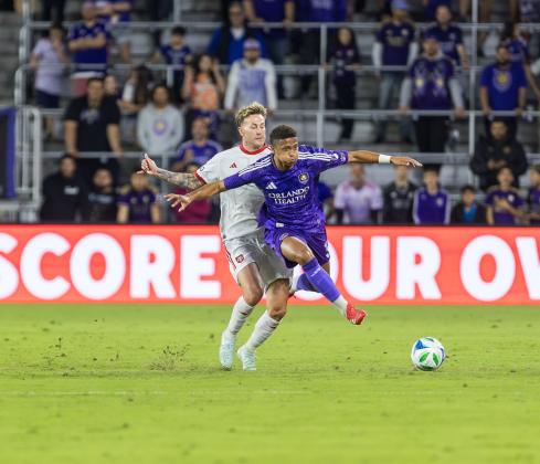 Rafael Santos skips over a player to chase the ball and center the ball. The left wingback is one of the stars of Orlando City. PHOTO/TAYLOR MCFEE