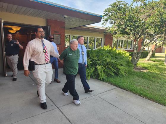 St. Cloud Police detectives lead Gene Stuller away to the Osceola County Jail after his arrest in connection to a 1991 murder case. PHOTO/KEN JACKSON