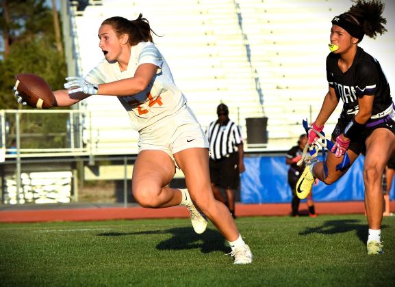 Harmony's Kinzie James runs from a Celebration defender and stretches for yardage in the Longhorns' 26-6 win over Celebration in the District 4A-10 championship game. PHOTO/KATIE WILLIAMS