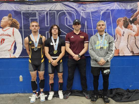 From left, Dominic Trombetta, Mikey Ziss, Coach Cory Aun and Santos Torres pose after the state weight lifting meet.  Trombetta and Torres both reached the podium in the Class 3A 129-pound weight class; while Ziss won two gold medals taking both the Olympic and Traditional championships at 119 pounds. PHOTO/ST. CLOUD HIGH SCHOOL