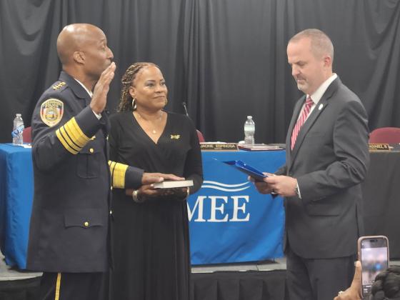 Orange County Deputy County Administrator of Public Safety Danny Banks swears in Charles Broadway Tuesday as Kissimmee's new Police Chief. PHOTO/KEN JACKSON