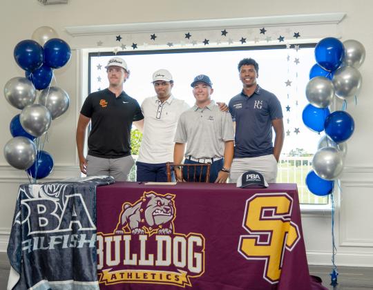 St. Cloud’s T.J. Griffin and Espn Pool, with family, coaches and teammates, signed college scholarships last week.
