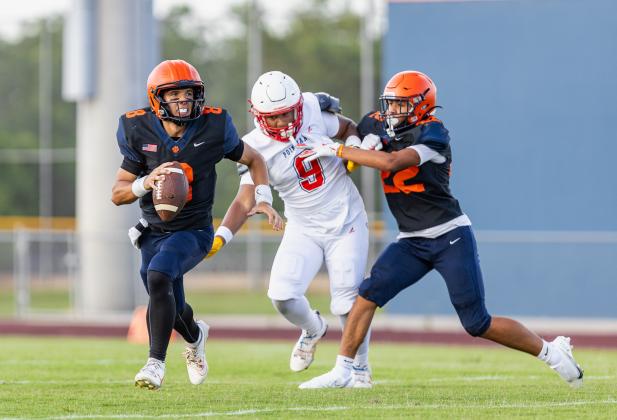 Toho Tigers quarterback Sabby Meassick evades a pass rush during their spring game against the Poinciana Eagles. (Photo/Taylor McFee)