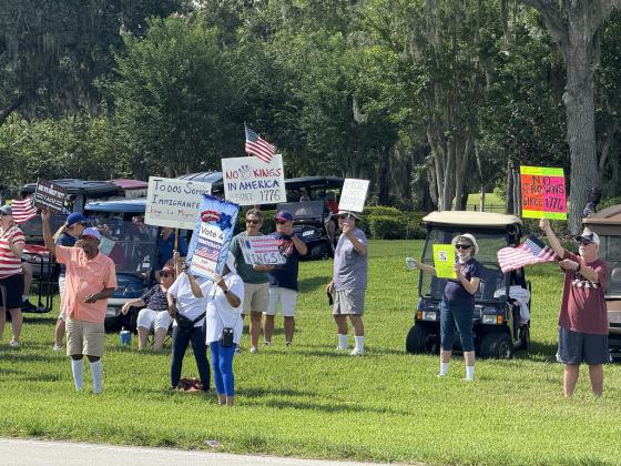 As part of the nationwide "No Kings" day of defiance, a protest was held Saturday morning outside of the gates of Solivita along Cypress Parkway in Poinciana. (Photo/Lisa Concepcion)