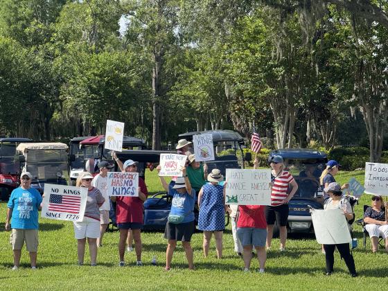 As part of the nationwide "No Kings" day of defiance, a protest was held Saturday morning outside of the gates of Solivita along Cypress Parkway in Poinciana. (Photo/Lisa Concepcion)