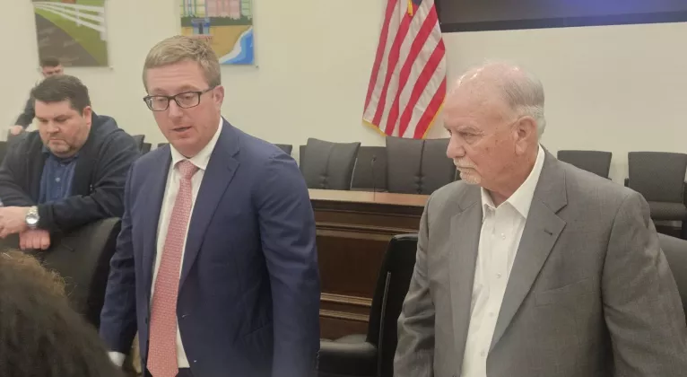 House Budget Chairman Lawrence McClure, in tie, and Senate Appropriations Chairman Ed Hooper, right, discuss the state budget. (NSF Photo/Jim Turner)
