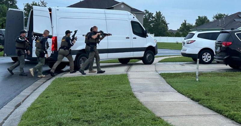 Tuesday morning, ICAC detectives, with guns drawn, served a residential search warrant on a home in the Crescent Lakes subdivision, where Ryan Brijlal was interviewed by detectives. (Photo/Osceola County Sheriff's Office)