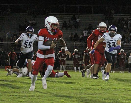Poinciana's Kamari Lewis (8) rushes to mid-field while Celebration's Michael Macera (33) pursues at Poinciana High School on Friday. (Photo/Michelle Kostuch)