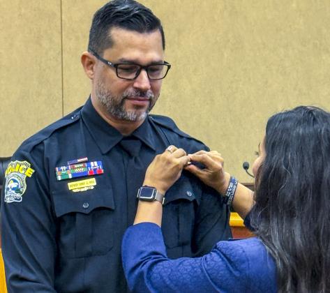 New SCPD Deputy Chief Jacob Ruiz gets his insignia pinned by wife Sadia Baxter at Tuesday's swearing-in ceremony.  (Photo/St. Cloud Police)