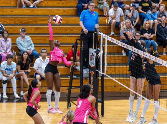 Osceola's Jordin Southall attempts to hit through the Winter Park defense of Amber McClain (11) and Isabel Incinelli (13) in Tuesday's five-set match at Winter Park. (Photo/Taylor McFee)