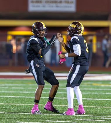 St. Cloud's Jaden Irons (1, left) and Stacy Taylor celebrate after another interception in the Bulldogs' big win. (Photo/Taylor McFee)