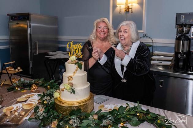 At the Osceola Council on Aging’s 50th Anniversary celebration in February 2021, Beverly Hougland (right) cut the ceremonial cake with current CEO Wendy Ford. (Photo/Osceola Council on Aging)