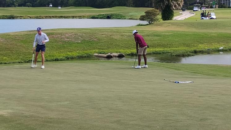 Ayden Febres attempts a birdie putt on the 3rd hole Tuesday. The freshman captured medalist honors with a 7-under 65. (Photo/J. Daniel Pearson)