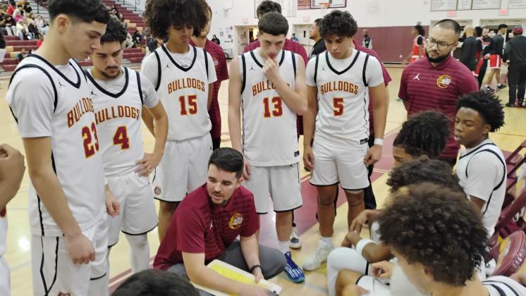 St. Cloud coach Tommy Billiteri talks strategy with his team during a fourth quarter timeout. The undaunted, rebuilt team is 8-1 now on the season. (Photo/J. Daniel Pearson)