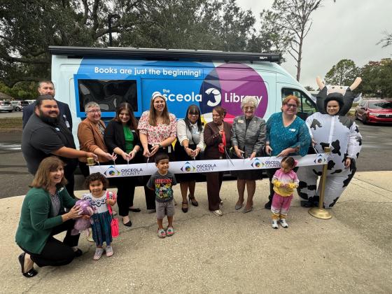 County and library officials cut the ribbon Tuesday on OLLie – the new Osceola Library Link van, fully equipped to serve as a Library on the Move to places not near existing libraries. (Photo/David Chivers)