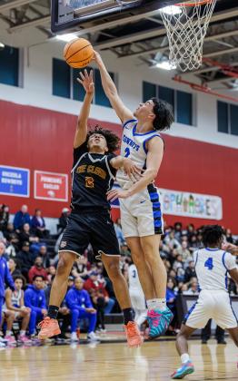 Deuces, but no deuce. A pair of 2s, Osceola's Jordan Mason and St. Cloud's Nate Thompson, battle for the ball and Mason blocks a shot/ (Photo/Taylor McFee)