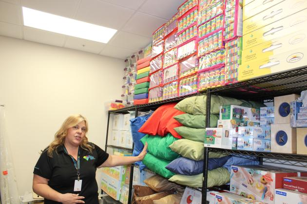 ELC CEO Amanda Kelkenberg shows off a fully-stocked closet of supplies for parents that its new space has room for. (Photo/Ken Jackson)