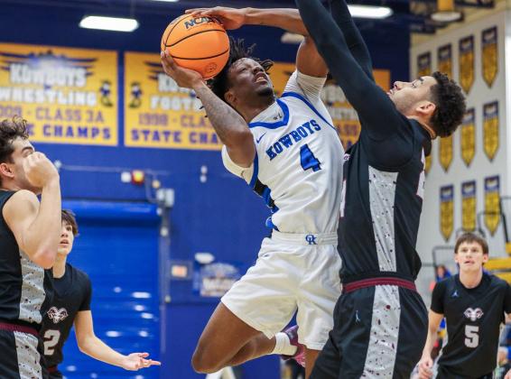 Osceola's Jahmel Hill drives to the basket against Sarasota Riverview defenders in Saturday's 90-52 win. (Photo/Taylor McFee)