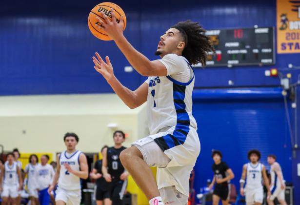 Osceola's Luke McCrimon drives to the hoop for two of his 20 points in Saturday's 63-62 Class 7A regional semifinal loss to Tampa Plant. He and Jordan Mason (in the background) played their last games for the Kowboys. (Photo/Taylor McFee)