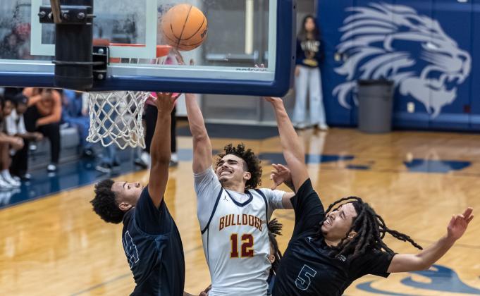 St. Cloud's Diomar Ortiz fights for a rebound and bucket in Saturday's District 7A-6 championship game, a 60-56 win over Lake Nona. (Photo/Taylor McFee)