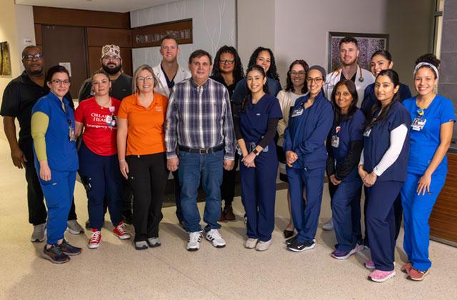 Thanks to quick work by the response care team at Orlando Health Emergency Room – Osceola, César Díaz Lira (fourth from left in front) was able to later reunite with that team that saved his life. (Photo/Orlando Health)