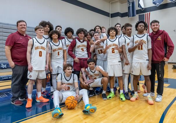 First One In the Case: nobody in this photo — and likely no one in the gym — was alive the last time (1971) the St. Cloud Bulldogs claimed a district title. (Photo/Taylor McFee)