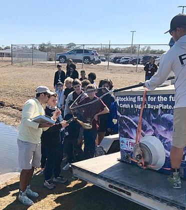 Students from John Prow’s St. Cloud Middle School science class scan fish they catch in a local pond and send information back to Fish and Wildlife Commission researchers. (Submitted photos)