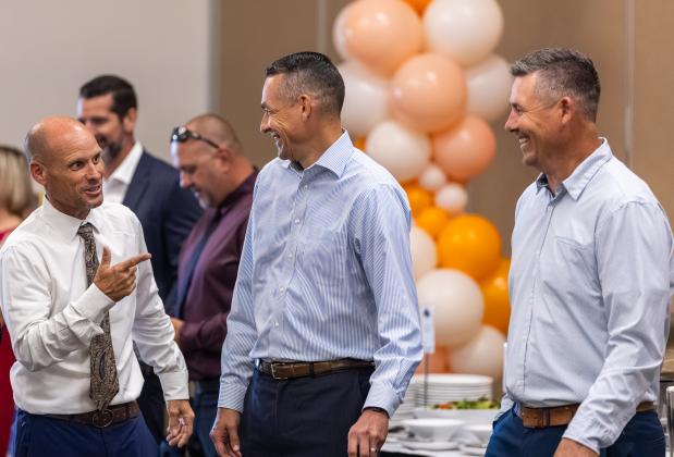 ADs of a feather: Bryan Smart, named OBC Athletic Director of the Year for the third straight year, shares a moment at the banquet with brothers Joey and Travis James, the ADs at Harmony and Gateway. (Photo/Taylor McFee)