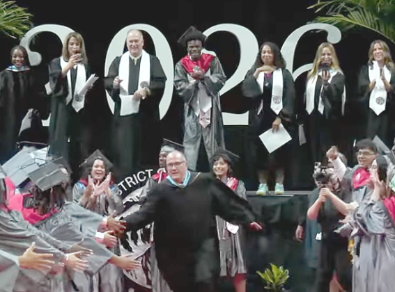 You don’t see this every day: Gateway High principal James Long takes a “spur of the moment” lap through the Class of 2026 at the May 21 graduation ceremony. (Photo/Osceola County School District) 