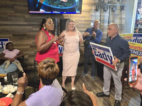Angela Eady, left, celebrates defending her Kissimmee Commission seat with Commissioner Janette Martinez, who moves on to a November runoff to keep her seat. (Photo/Ken Jackson)