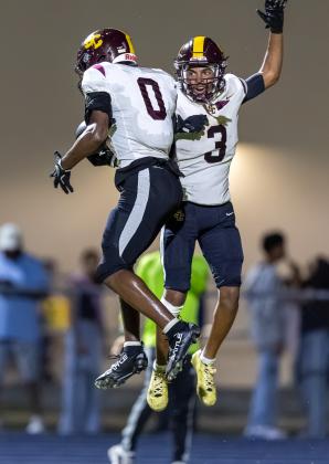 St. Cloud's Matthew Blenman (0) and Stacy Taylor (3) were clearly excited about the victory ... or maybe it was about Coach Mike Short's birthday win? (Photo/Taylor McFee)