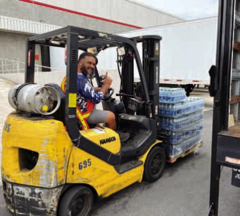 A Disney cast member delivers water bottles to the Osceola County on Aging in preparation for Hurricane Ian in September. PHOTO/OSC. COUNCIL ON AGING