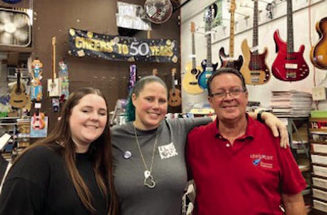 The definition of a family small business, Lewis Music — Paul, Brandie and Stephanie — in downtown Kissimmee celebrated 50 years of serving the community Saturday. PHOTO/DAVID CHIVERS