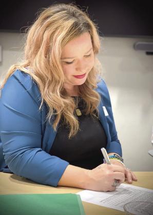 Rev. Downey signs the contract on Hope Partnership’s affordable housing hotel conversion project. PHOTO/HOPE PARTNERSHIP