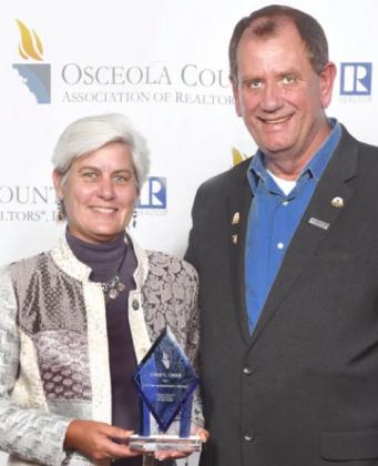 Cheryl Grieb accepts OSCAR Lifetime Achievement award from President Donnie Martinez. SUBMITTED PHOTO