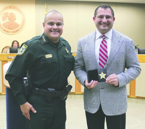 He solemnly swears: Osceola Sheriff Marcos Lopez swore in School Superintendent Mark Shanoff as an honorary Special Deputy last week. PHOTO/KEN JACKSON