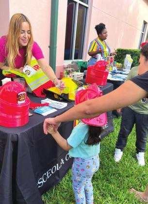 Osceola County's Public Education Coordinator Bethzaida Garcia connects with young firefighting fans. PHOTO/OSCEOLA FIRE RESCUE/EMS