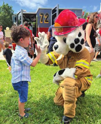 Sparky the Fire Dog makes a new friend. PHOTO/OSCEOLA FIRE RESCUE/EMS