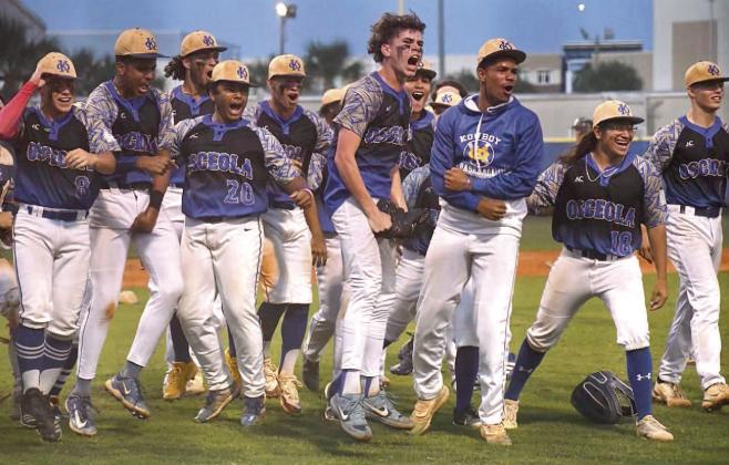 Osceola players wait to greet Raul Ramirez in the dugout after he slugged a home run to tie the District 7A-9 title game, which the Kowboys won. PHOTO/CARRIE PALMI