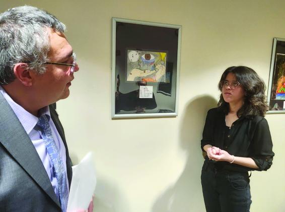 Osceola Clerk and Comptroller Kelvin Soto discusses a piece of art in the Courthouse’s N.E.S.T. Gallery with Poinciana High School artist Yarelis Torres. PHOTO/KEN JACKSON