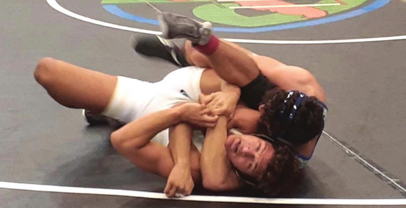 Osceola’s Nolin Eaddy, top, pins South Dade wrestler Daniel Espino-Gonzalez in the 182-pound weight class. NEWS-GAZETTE PHOTO/J. DANIEL PEARSON