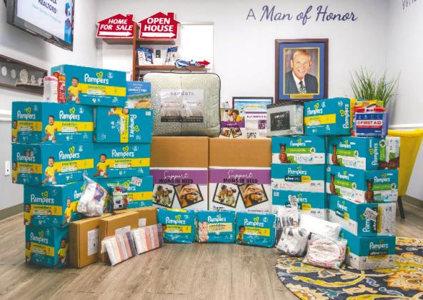 Osceola REALTORS once again joined forces with Two Men and a Truck for the annual Movers for Moms campaign, benefitting Help Now of Osceola. This year’s drive resulted in the collection of more than 1,000 essential items donated to local shelters. (Photo/OSCAR)