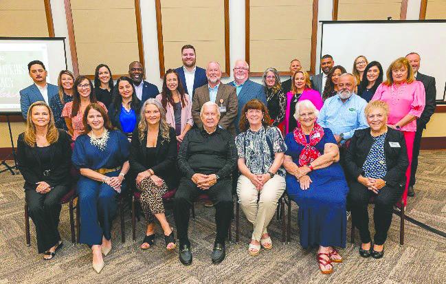 Tommy Tompkins (seated center) helped found the Education Foundation Osceola County 40 years ago, and is now being honored with a scholarship in his name to go to a graduating county senior. (Photo/Education Foundation Osceola)
