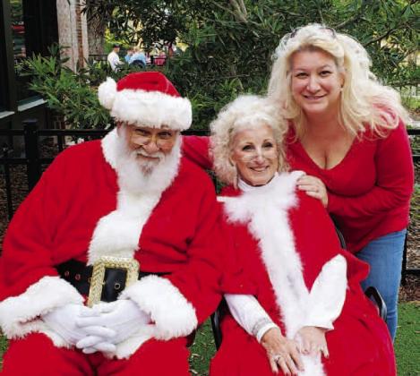 Peter and Pauline Coschignano, with Osceola Council on Aging CEO Wendy Ford (right) dressed up as Mr. and Mrs. Claus for an Osceola Council on Aging holiday function. PHOTO/OSCEOLA COUNCIL ON AGING
