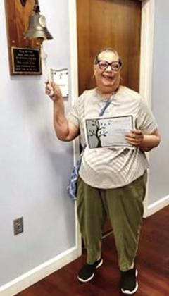 Awilda Donato, Case Management Director at the Osceola Council on Aging, rings the bell at her doctor’s office signifying her breast cancer treatments were over. SUBMITTED PHOTO